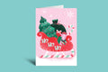 Christmas-themed greeting card with a sleigh, trees, and 'Ho Ho Ho' text on a pink background.