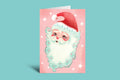 Christmas card with Santa Claus face surrounded by flowers and snowflakes on a pink background