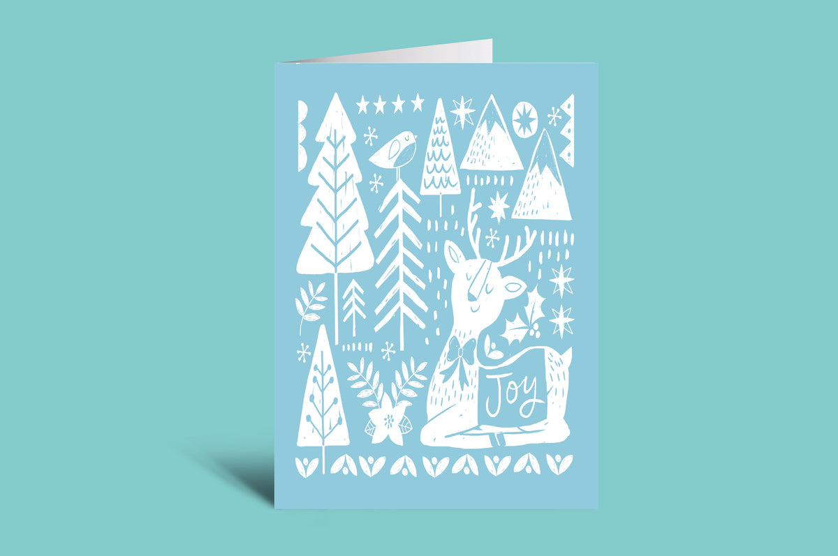 Greeting card with white forest design on a light blue background