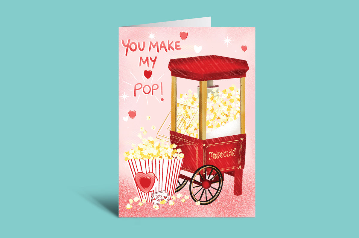 Greeting card with a popcorn machine and text 'You Make My Pop!' on a pink background