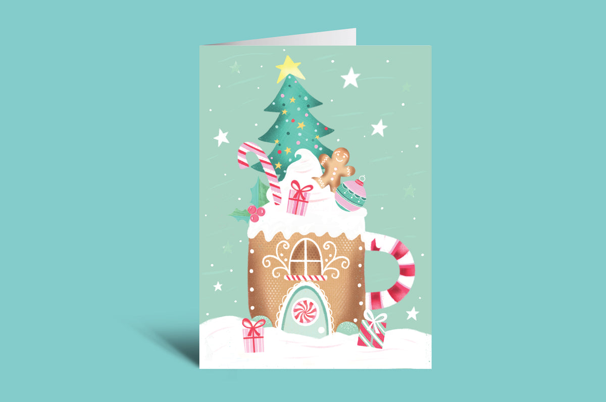 Greeting card with a gingerbread house and Christmas tree design on a light green background