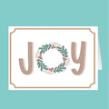 Card with 'JOY' text and wreath design on a teal background