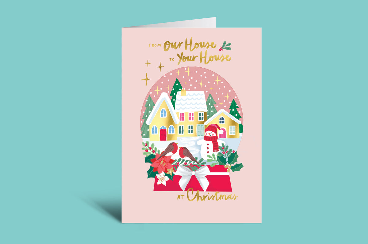Christmas card with a house illustration on a pink background