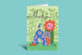 Colorful greeting card with a floral design and 'thank you' text on a green background