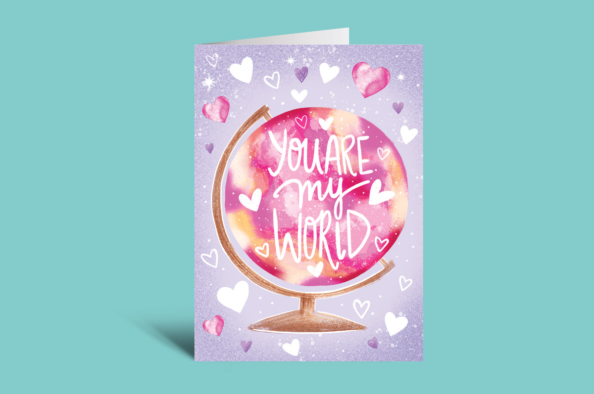 Greeting card with 'You are my world' text on a colorful globe design against a light green background.