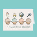 Baby shower card with cupcakes and baby items on a teal background