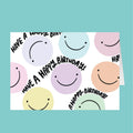 Colorful birthday card with smiley faces and 'Have a Happy Birthday!' text on a teal background
