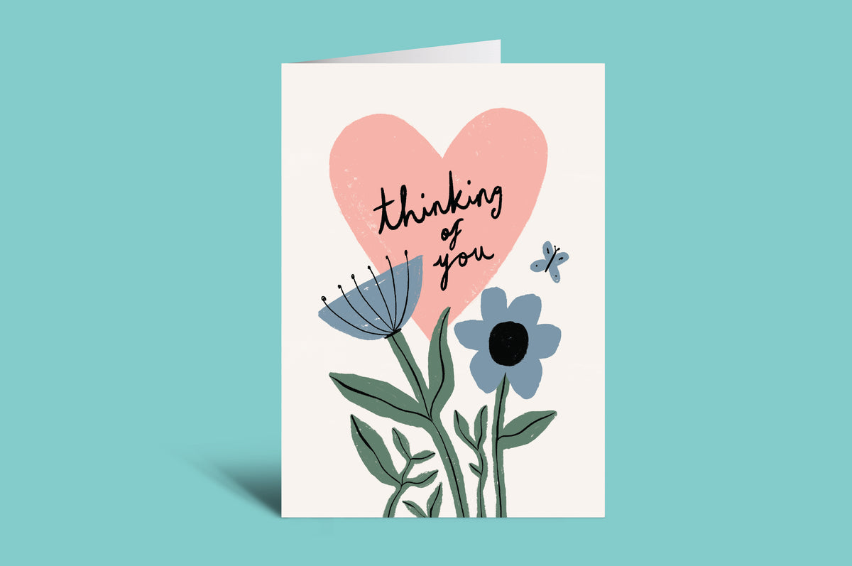 Greeting card with pink heart and flowers on a green background