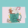 Christmas-themed card with a mug, cookies, and candy on a light pink background