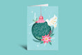 Greeting card with Christmas ornament design and 'Peace on Earth' text on a green background