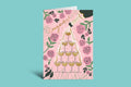 Greeting card with champagne tower design on a pink background with floral elements against a green border.