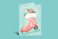 Christmas card with pink stocking, gingerbread man, and candy canes on a green background