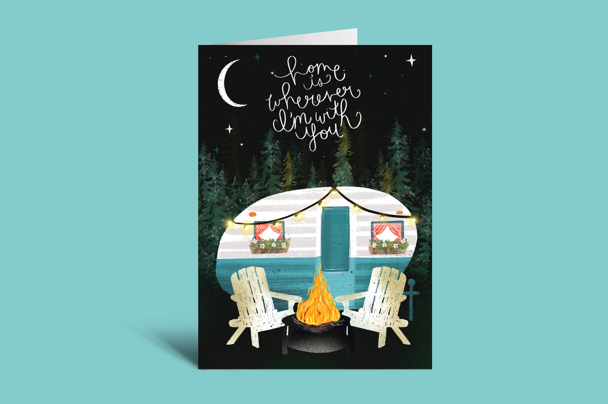 Card with a camper, chairs, and campfire on a green background