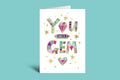 Greeting card with colorful gemstone design and text 'YOU ARE A GEM' on a green background