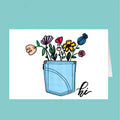 Card with a blue pocket full of colorful flowers and 'hi' text on a teal background