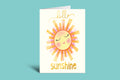 Greeting card with a sun illustration and 'hello sunshine' text on a green background
