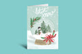 Christmas card with a snow globe design, snowman, and text 'let it snow' on a light green background.
