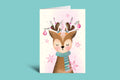 Greeting card with a deer illustration wearing a scarf on a light green background