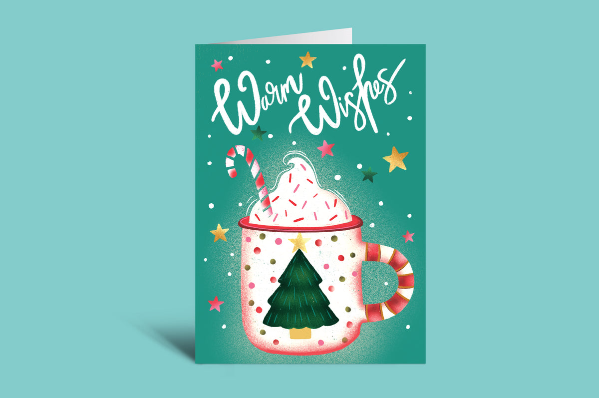 Christmas-themed greeting card with a mug of hot chocolate, candy cane, and tree on a green background.