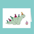 Birthday card with a dinosaur wearing party hats and a cupcake, on a teal background.