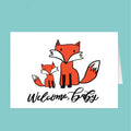 Greeting card with two foxes and 'Welcome, Baby' text on a white background