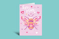 Greeting card with a bee design and 'bee mine' text on a pink background