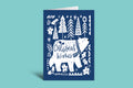 Blue Christmas card with white bear and text on a teal background