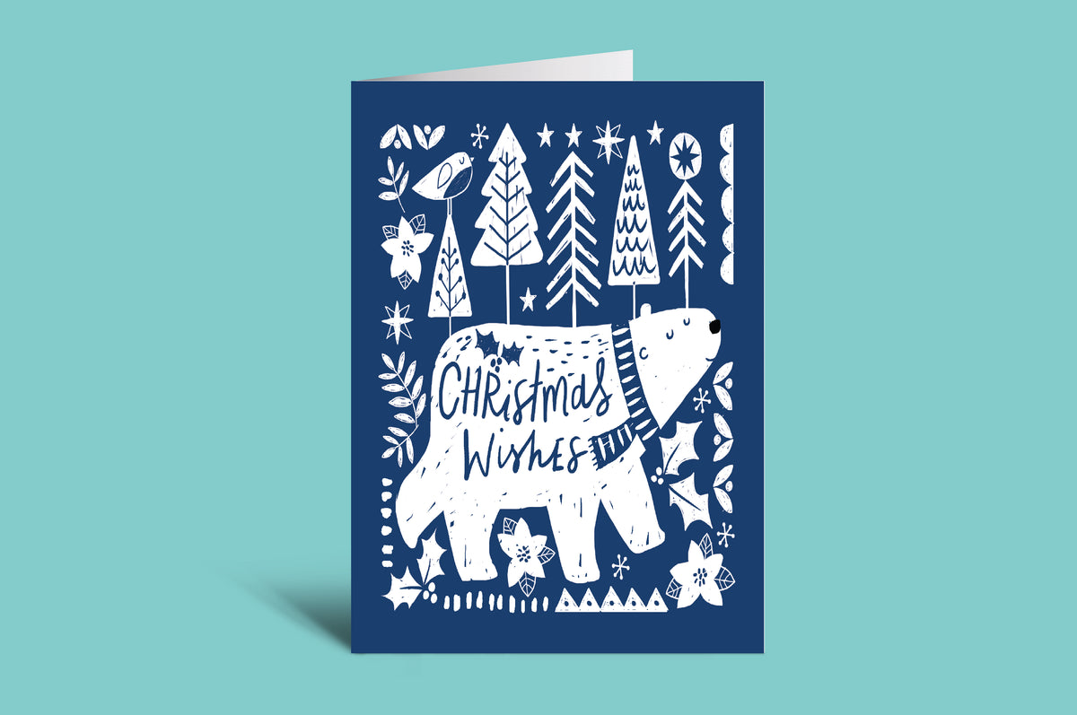 Blue Christmas card with white bear and text on a teal background