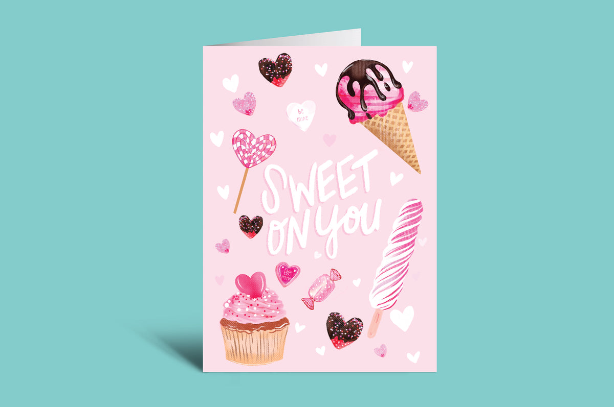 Greeting card with ice cream, cupcake, and heart illustrations on a pink background with a green border.