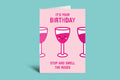 Birthday card with pink wine glasses and text on a light green background