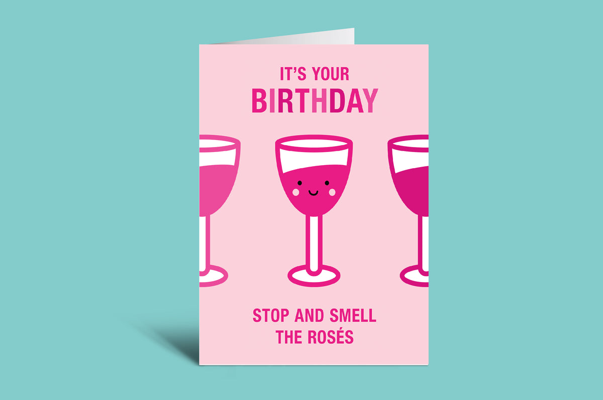 Birthday card with pink wine glasses and text on a light green background