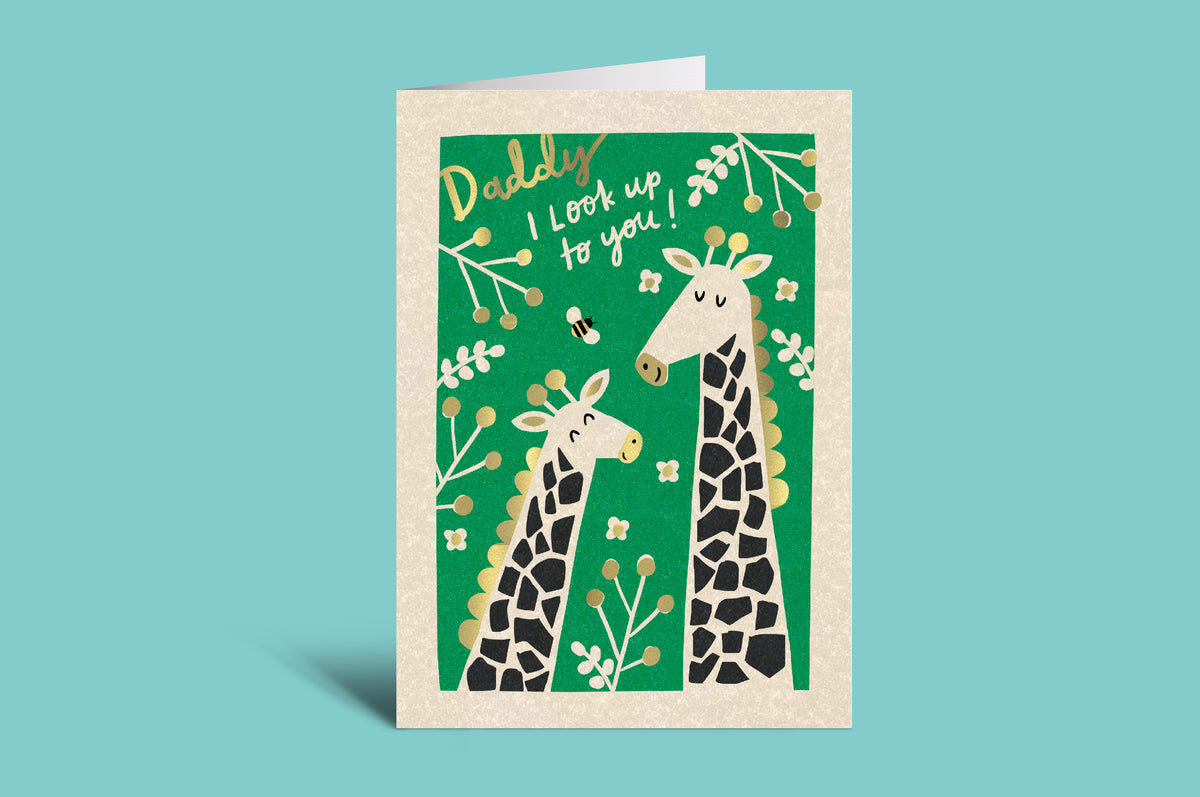Greeting card with two giraffes on a green background