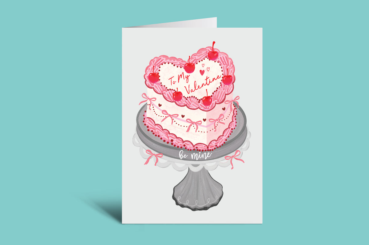 Valentine's Day card with a heart-shaped cake on a green background