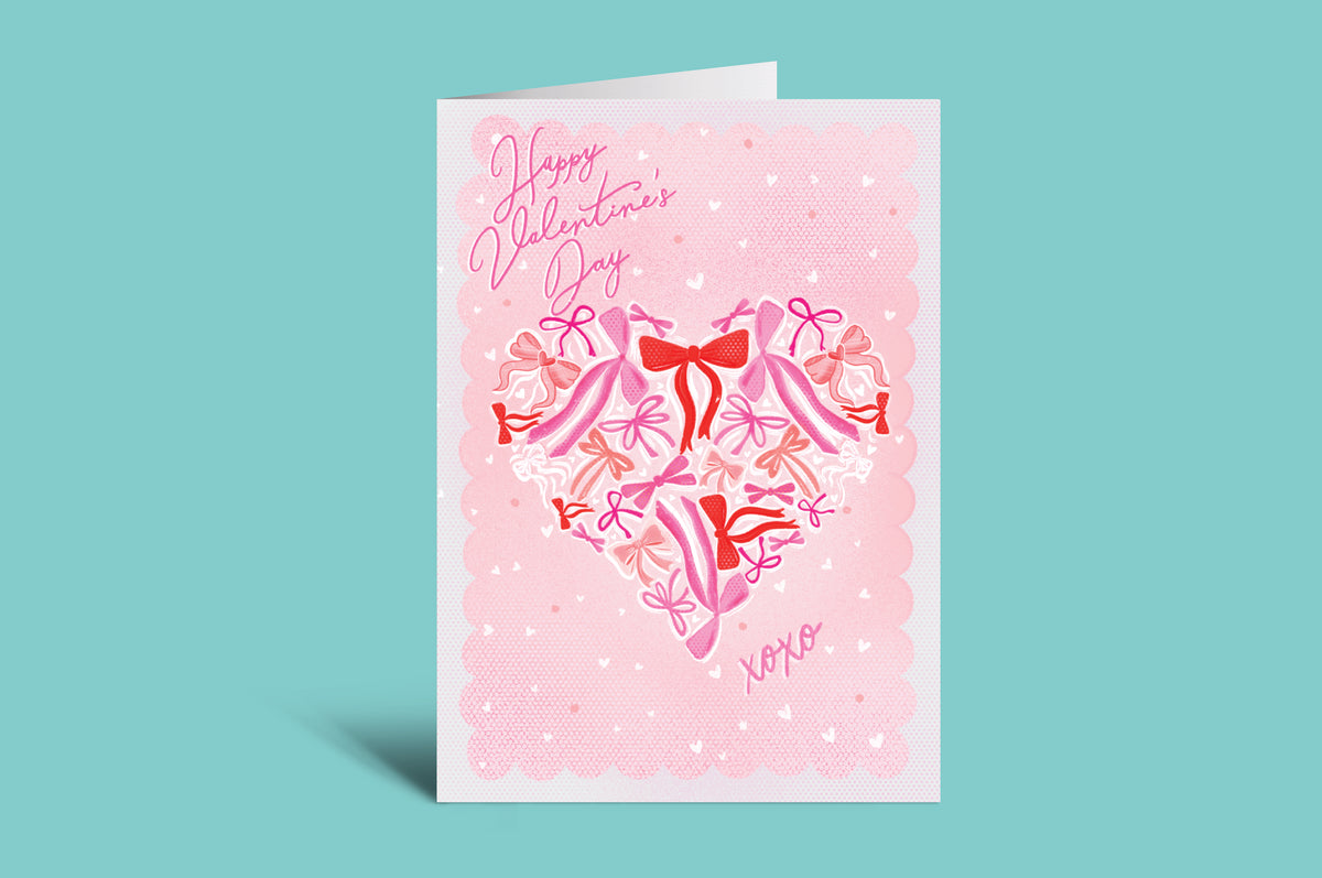 Valentine's Day card with pink polka dots and red and pink ribbons on a green background