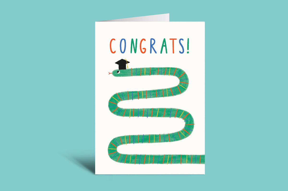 Greeting card with a snake wearing a graduation cap on a green background