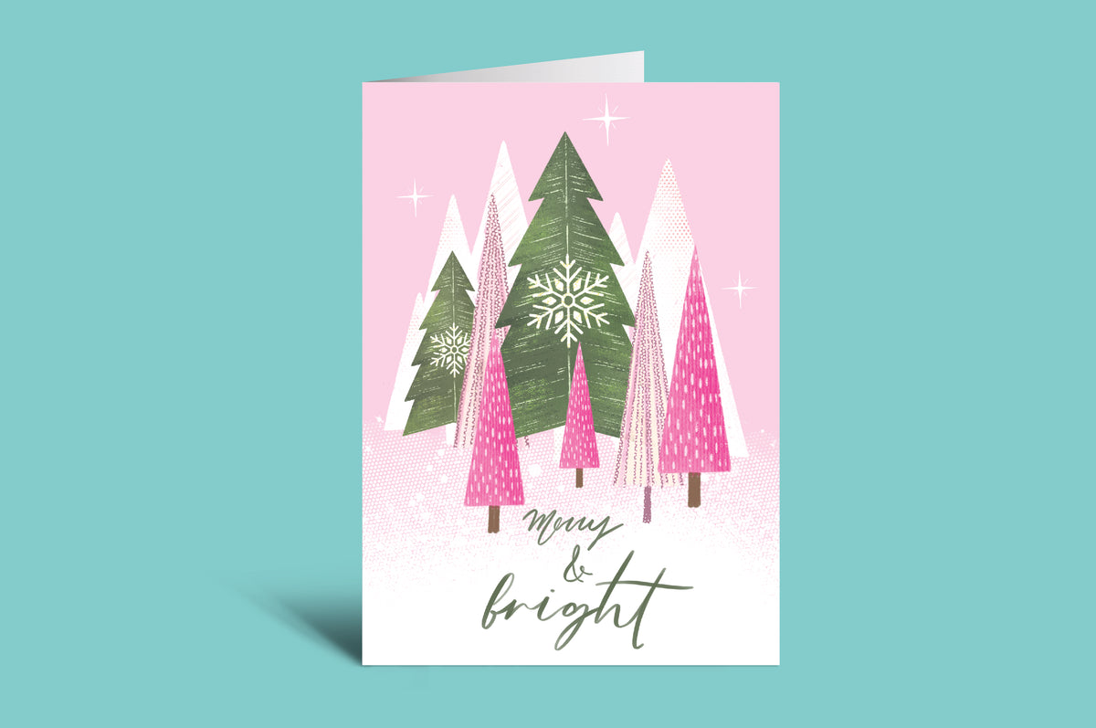 Christmas card with trees and 'Merry & Bright' text on a pink background