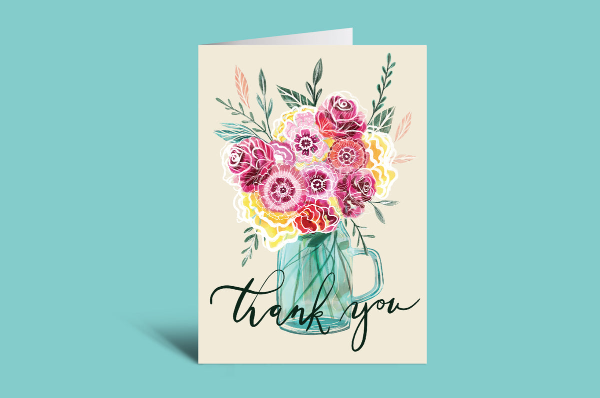 Greeting card with floral design and 'thank you' text on a green background