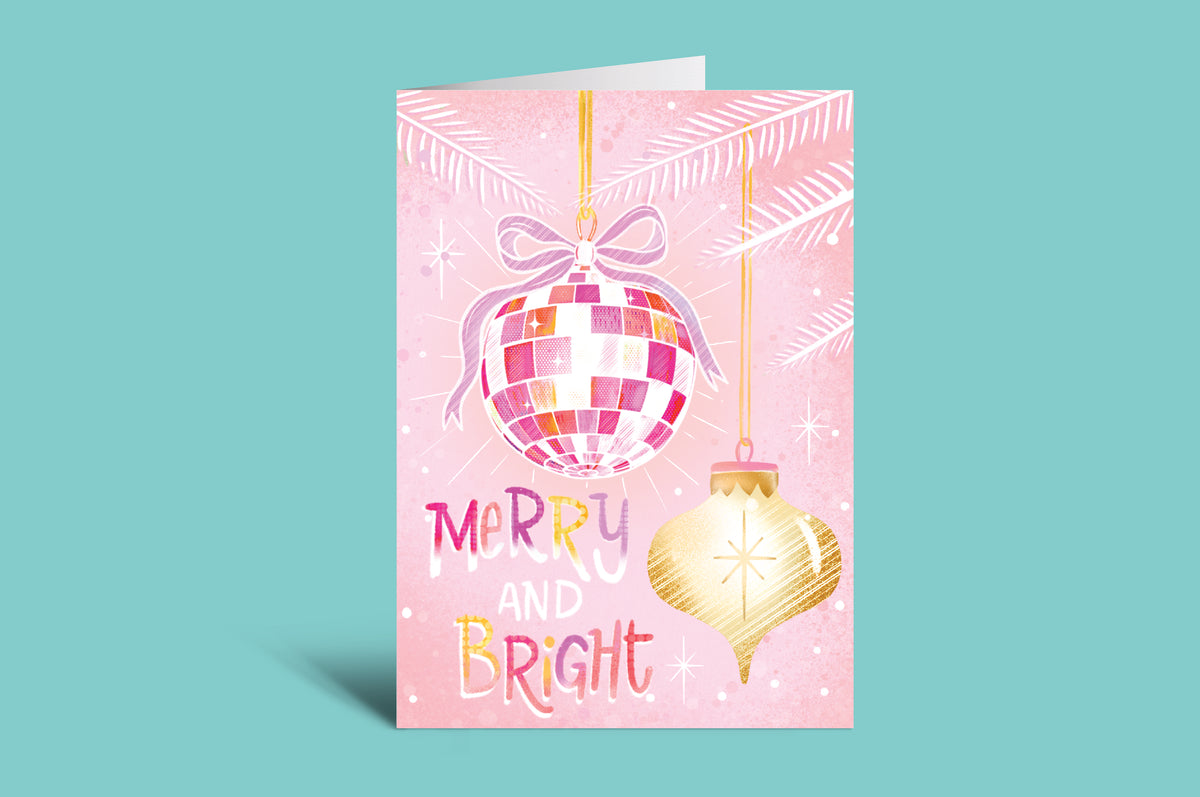 Greeting card with disco ball and Christmas ornament on a pink background