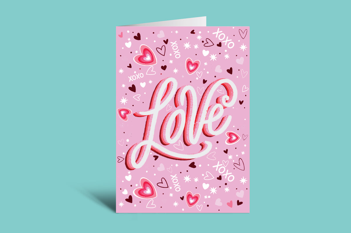 Pink card with 'Love' text and heart designs on a green background