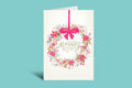 Greeting card with floral design and pink bow on a green background