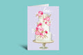 Greeting card with a cake illustration and flowers on a light purple background