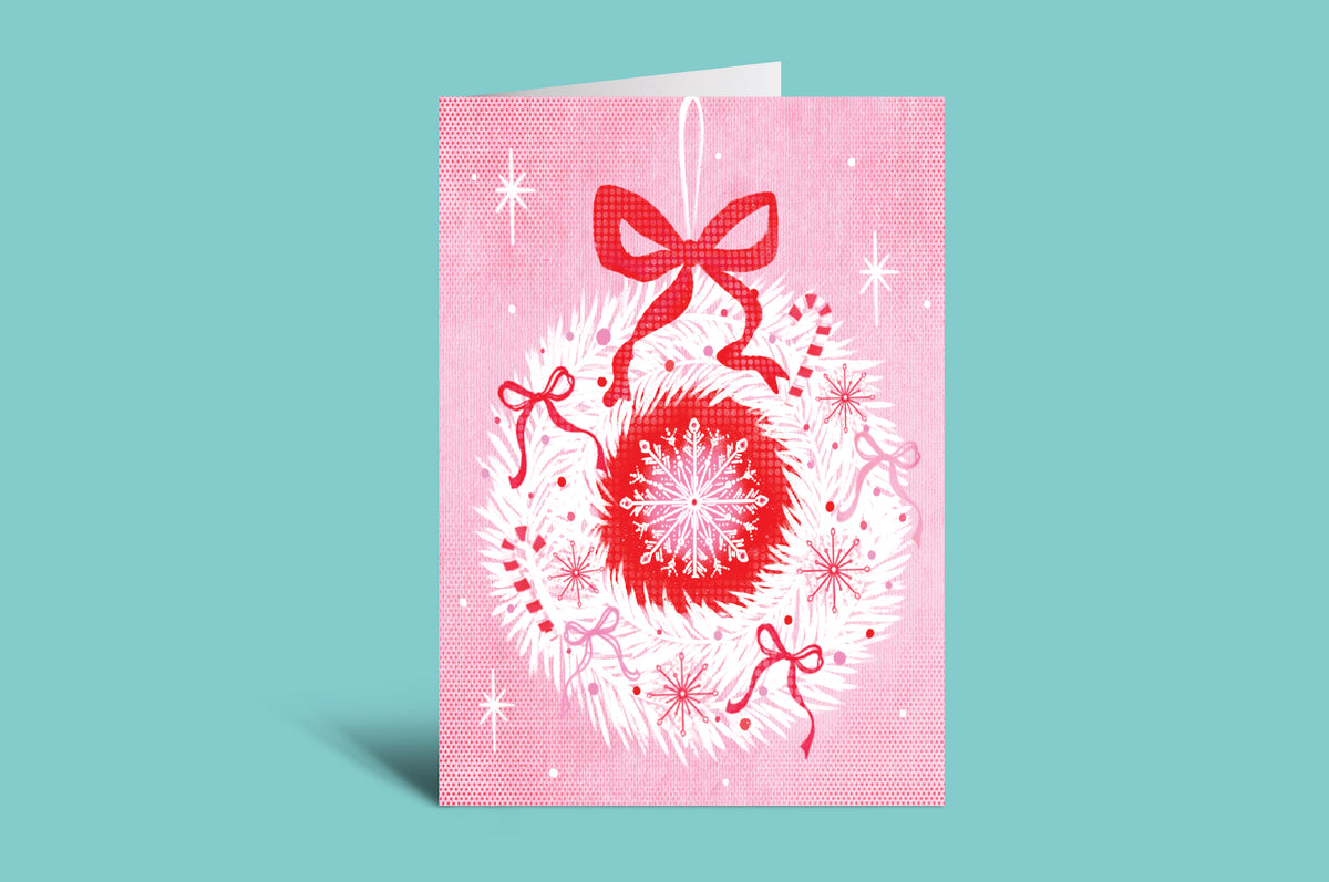 Greeting card with red snowflake and bows on a pink background