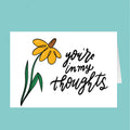 Yellow flower with 'you're in my thoughts' text on a teal background
