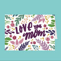 Greeting card with 'Love you mom' text and floral design on a teal background