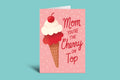 Greeting card with ice cream cone and cherry design on a pink background