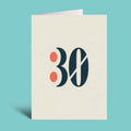 A vertical cream-colored greeting card with a folded top edge, featuring a stylized '30' graphic in dark navy and coral orange on the front, set against a solid turquoise background.
