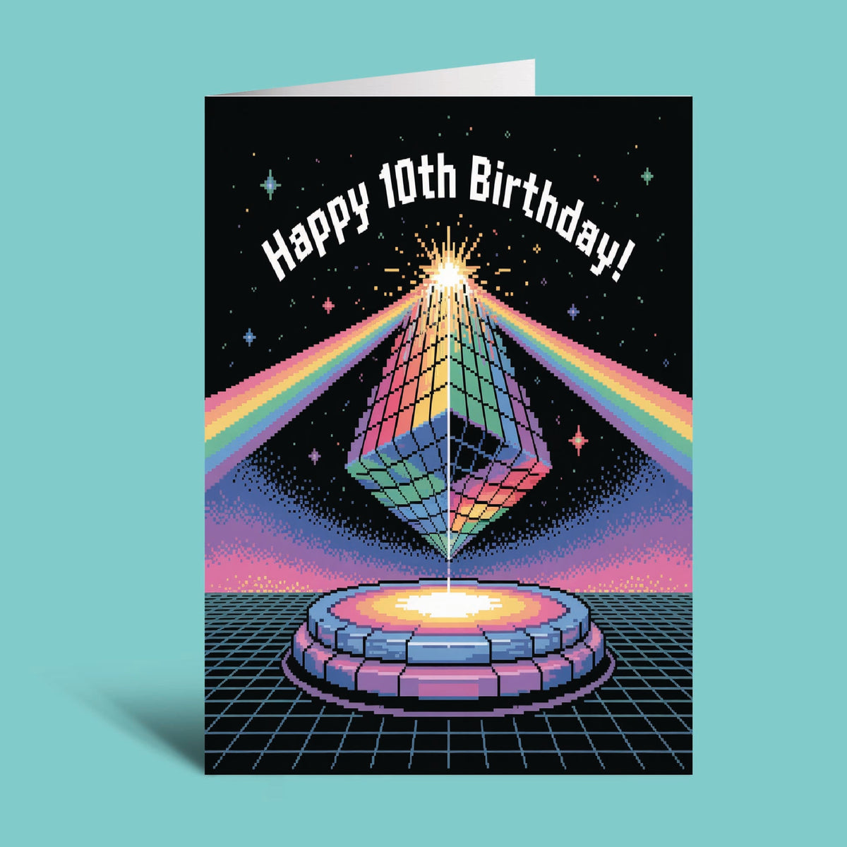 A retro-themed 10th birthday greeting card standing upright against a solid light teal background. The card features a colorful, pixel-art style illustration of a glowing pyramid on a circular platform with rainbow light beams against a starry black sky, with the text 'Happy 10th Birthday!' arched at the top.