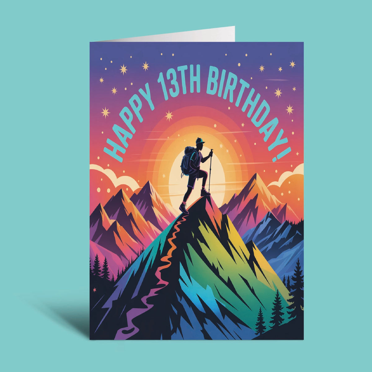 A vertical greeting card standing upright on a light aqua background. The card features a colorful illustrated mountain scene with a hiker silhouette, stars, and the text 'HAPPY 13TH BIRTHDAY!' in arched pastel lettering.