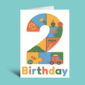 A white birthday card standing upright on a light aqua background. The card features a large stylized number 2 made of colorful toy-like puzzle pieces, with small illustrated objects inside the number and the word 'Birthday' in multicolored letters at the bottom.