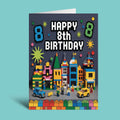 A folded birthday card standing upright against a solid light blue background. The card features a dark gray brick-patterned background with the text 'HAPPY 8th BIRTHDAY' in white pixel-style letters, flanked by two blue '8' numerals.